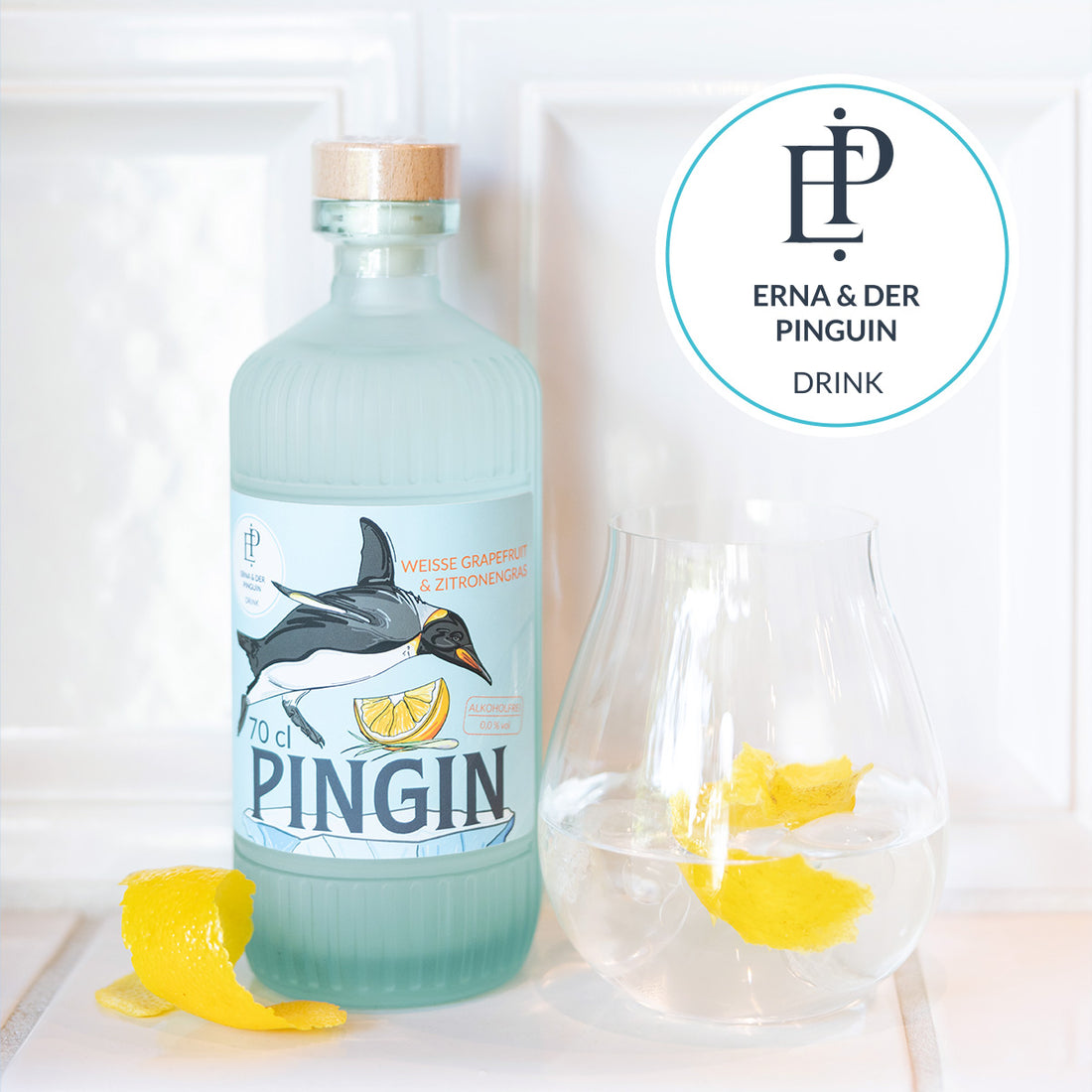 Ein Glas mit Zitronen und eine Flasche der alkoholfreien Gin-Alternative Pingin von Erna und der Pinguin.